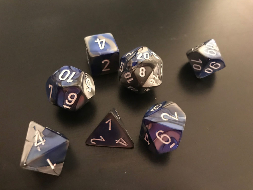 A set of blue-and-grey dice resting on a black background.