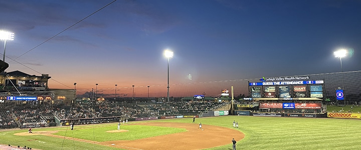 A baseball game at sunset.